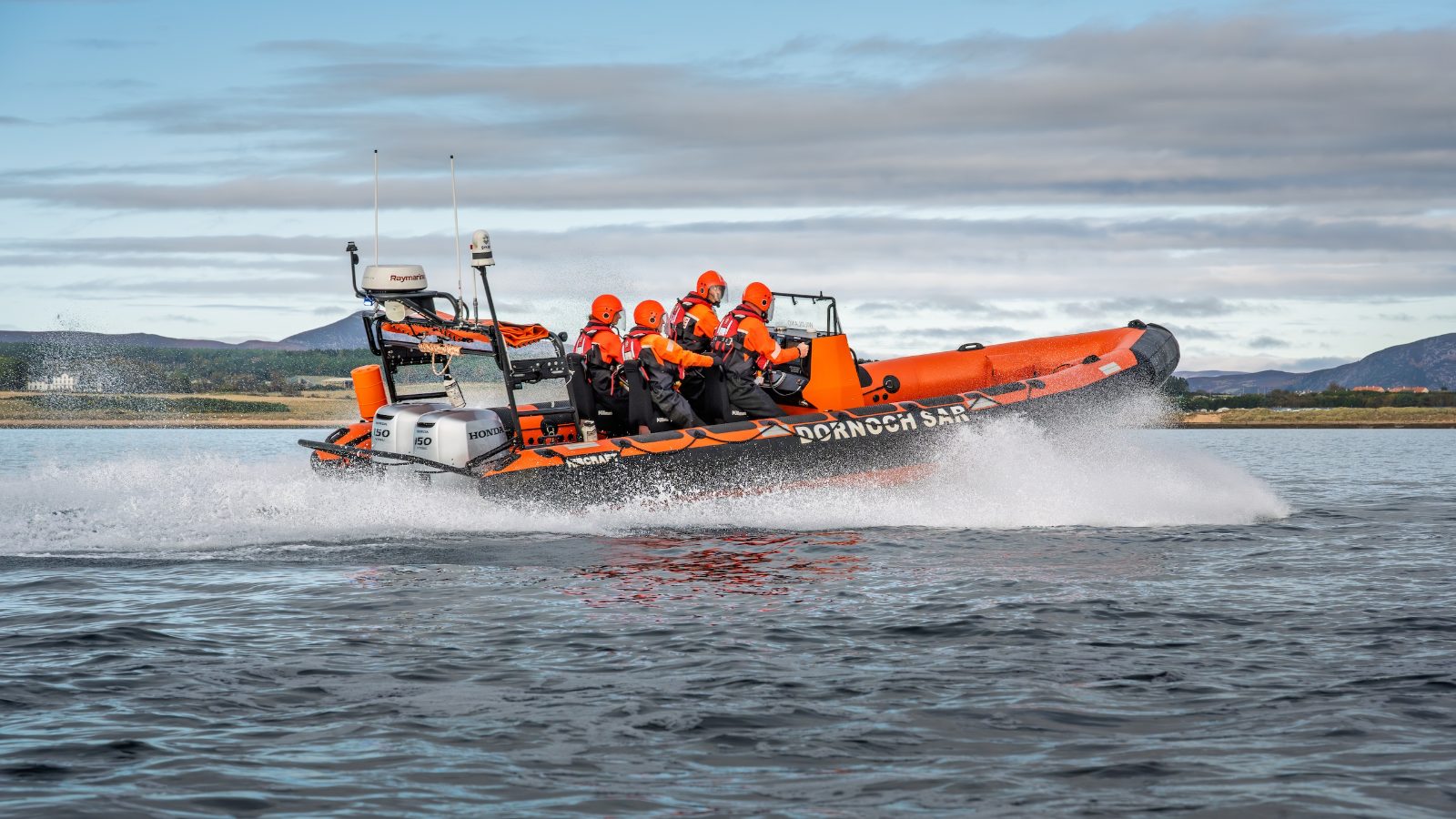 Search and rescue crew underway on a rigid inflatable lifeboat